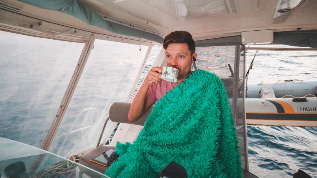 just a man with a blanket and hot tea at sea