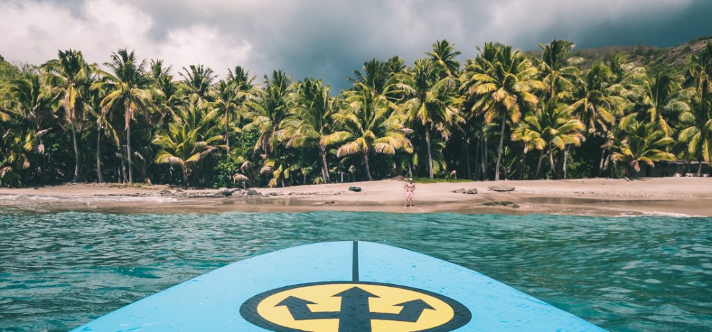 Stand up paddle boarding to a coconut paradise