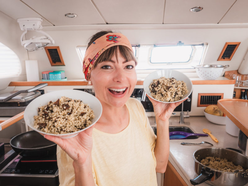 nikki wynn in the galley of s/v curiosity cooking up pasta