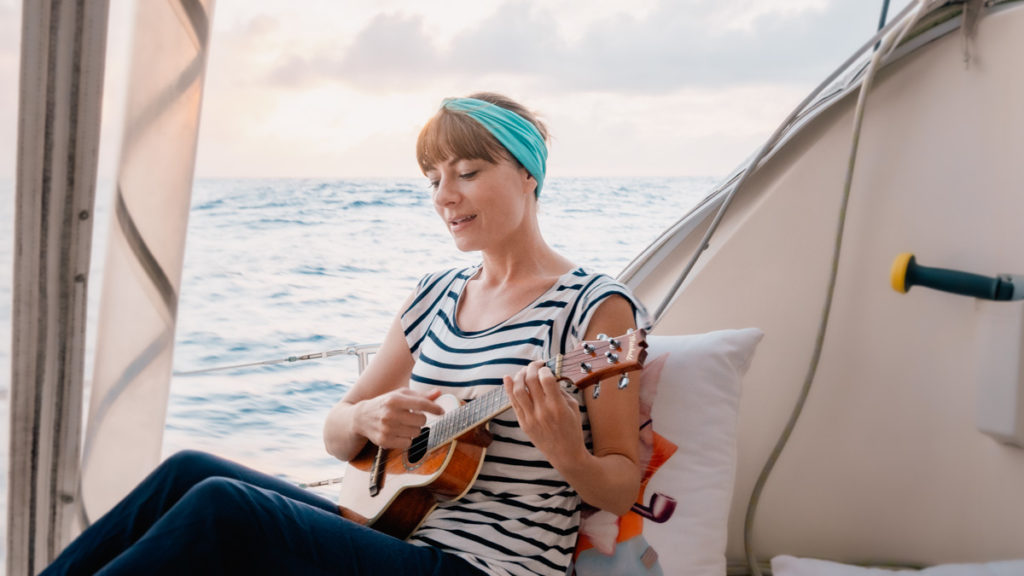 nikki wynn playing ukulele while sailing