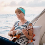 nikki wynn playing ukulele while sailing