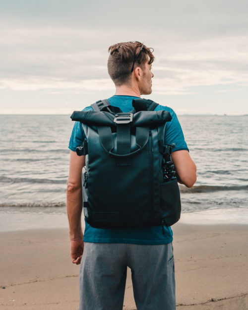 jason wynn with photography backpack at beach