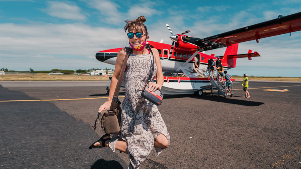 nikki wynn jumping for joy as she heads into a seaplane for a tour over fiji islands